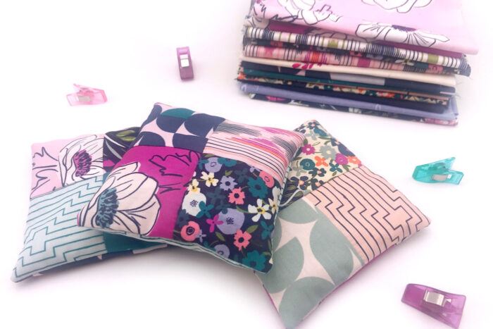 stack of lavender sachets tied up with ribbon on white table