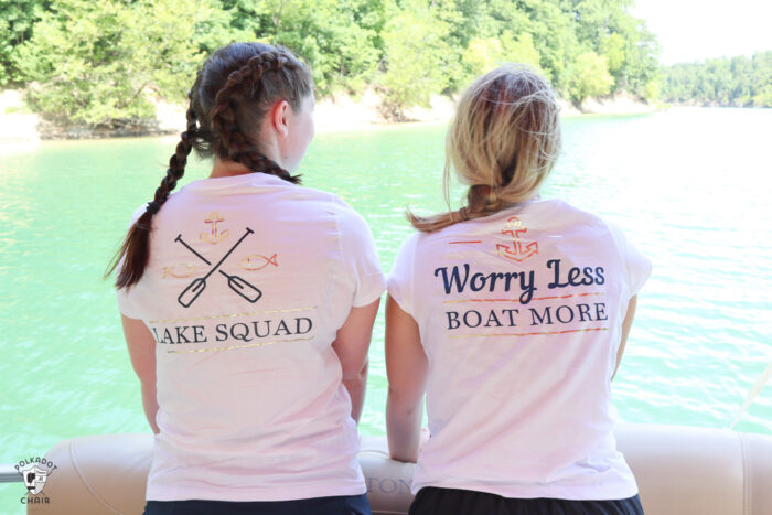 girl on boat looking out to lake wearing white t-shirt