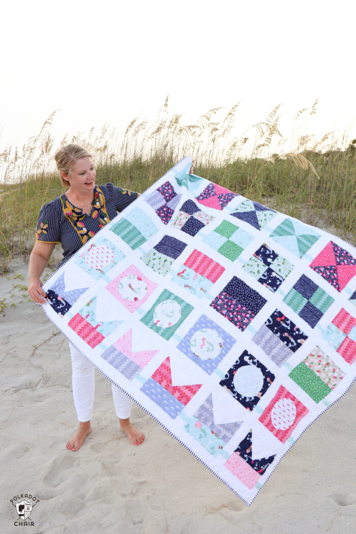 seas the day quilt pattern being held by woman