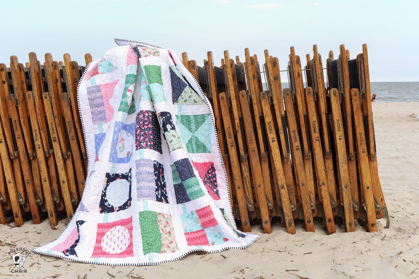 seas the day nautical quilt on wood beach chairs on beach
