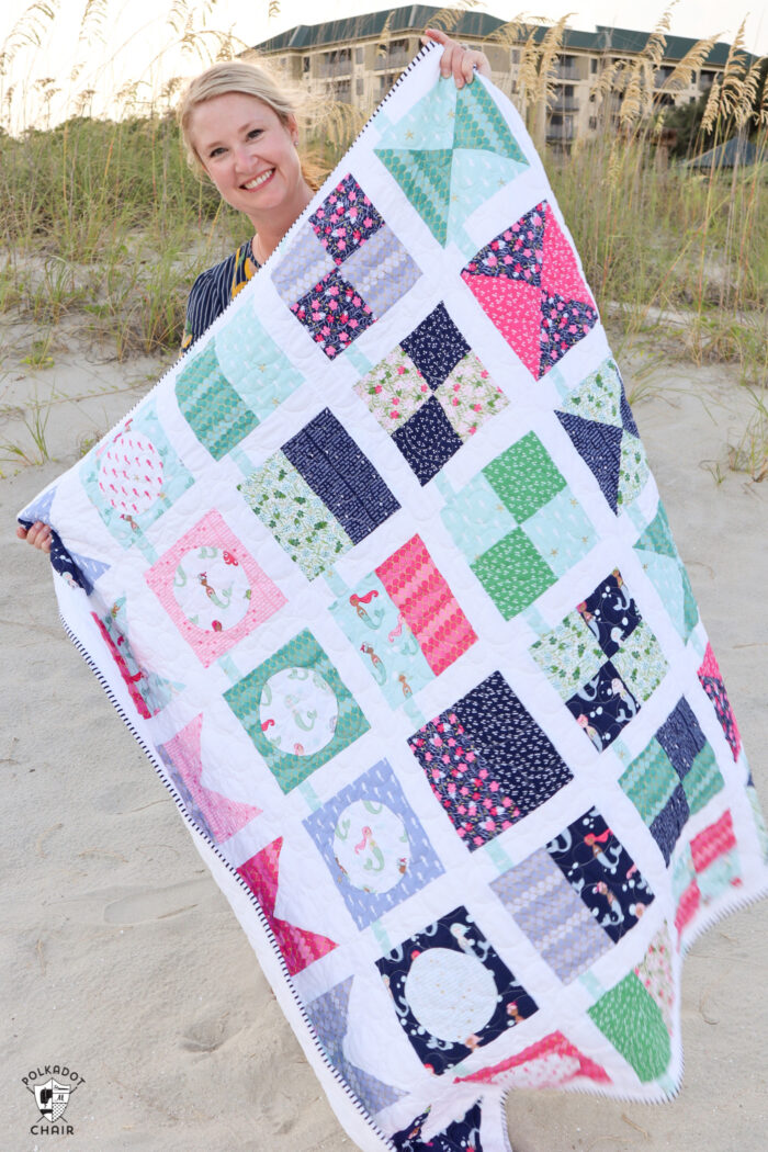 seas the day quilt pattern being held by woman