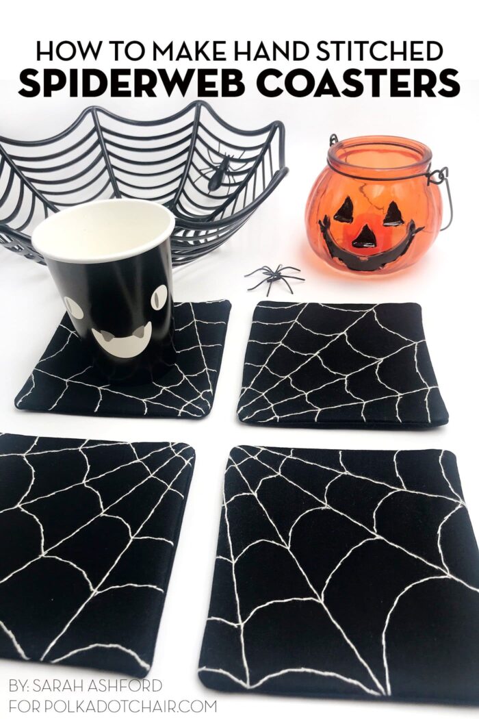 4 black and white spiderweb coasters on white table with halloween props