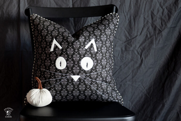 halloween pillows on black chair