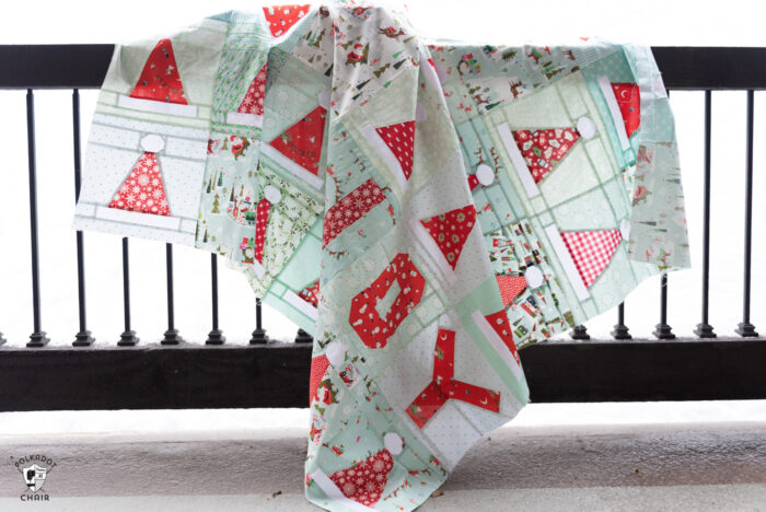 santa hat quilt on railing in snow