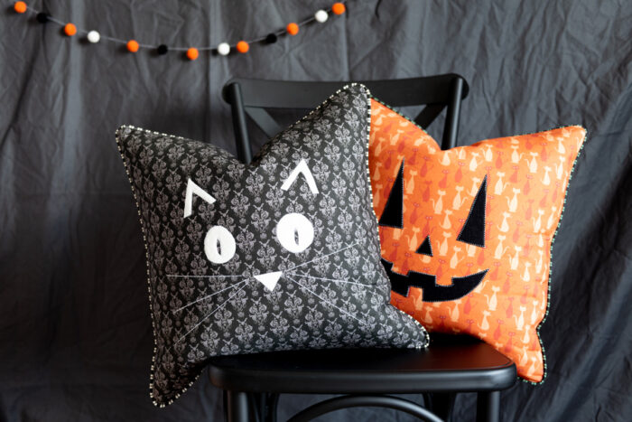 halloween pillows on black chair