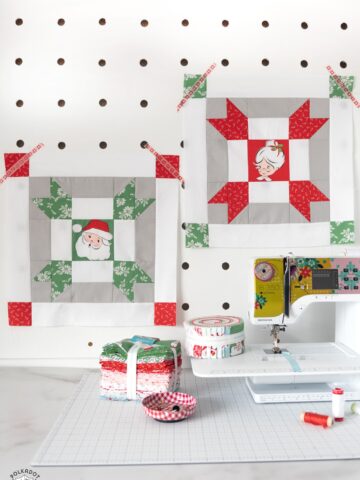 red and green christmas quilt blocks on peg board