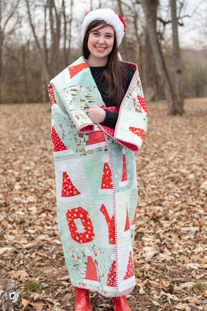 girl holding quilt outdoors