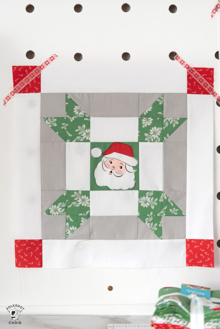 red and green christmas quilt blocks on peg board