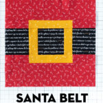 Photo of sewn santa belt quilt block on white cutting mat