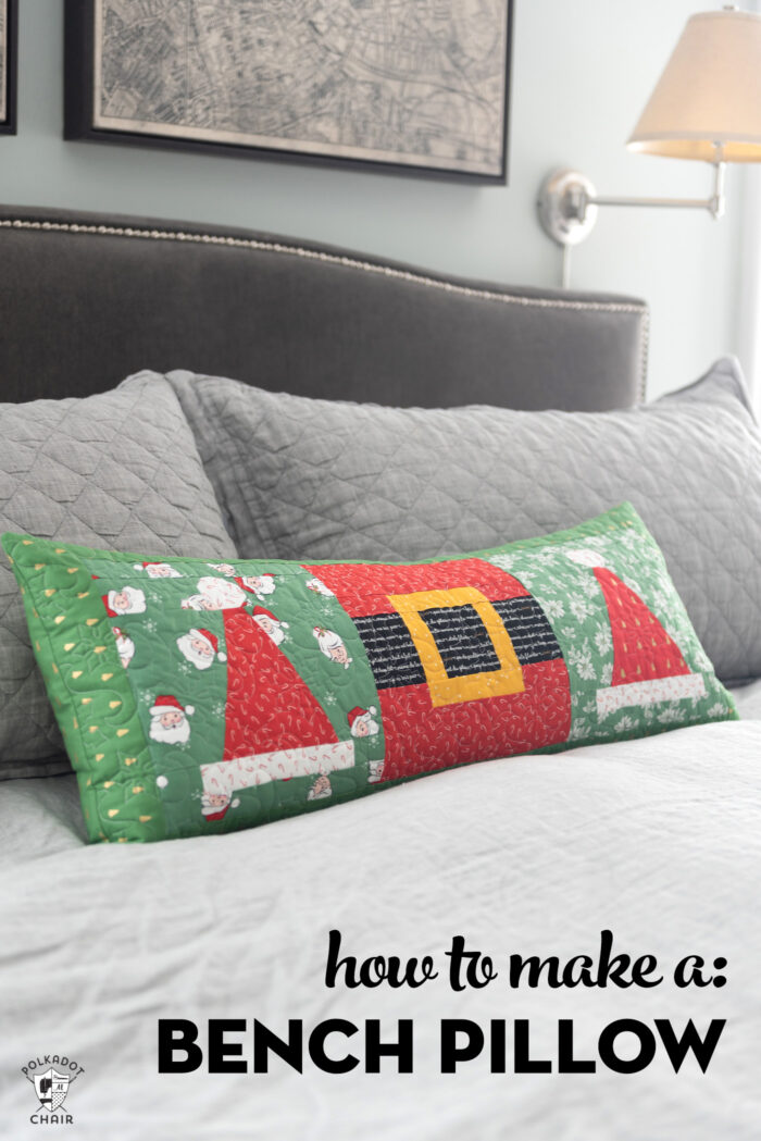 quilted christmas pillow on gray bed