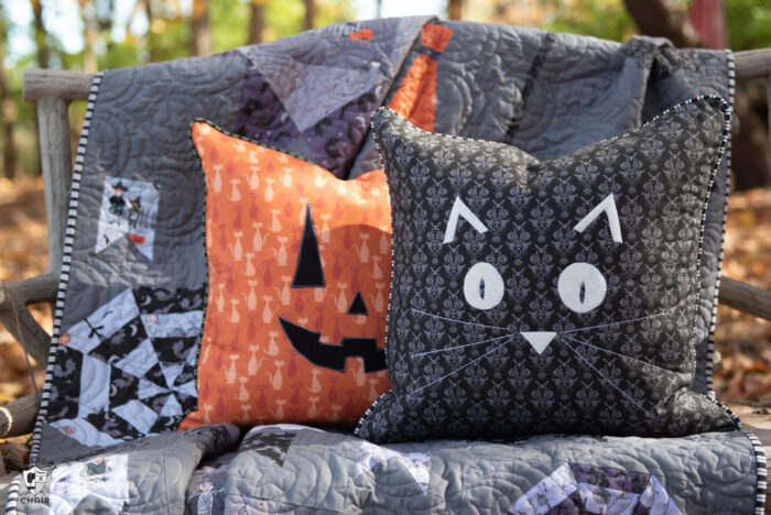 pillows and quilt on bench outdoors