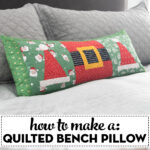 quilted christmas pillow on gray bed