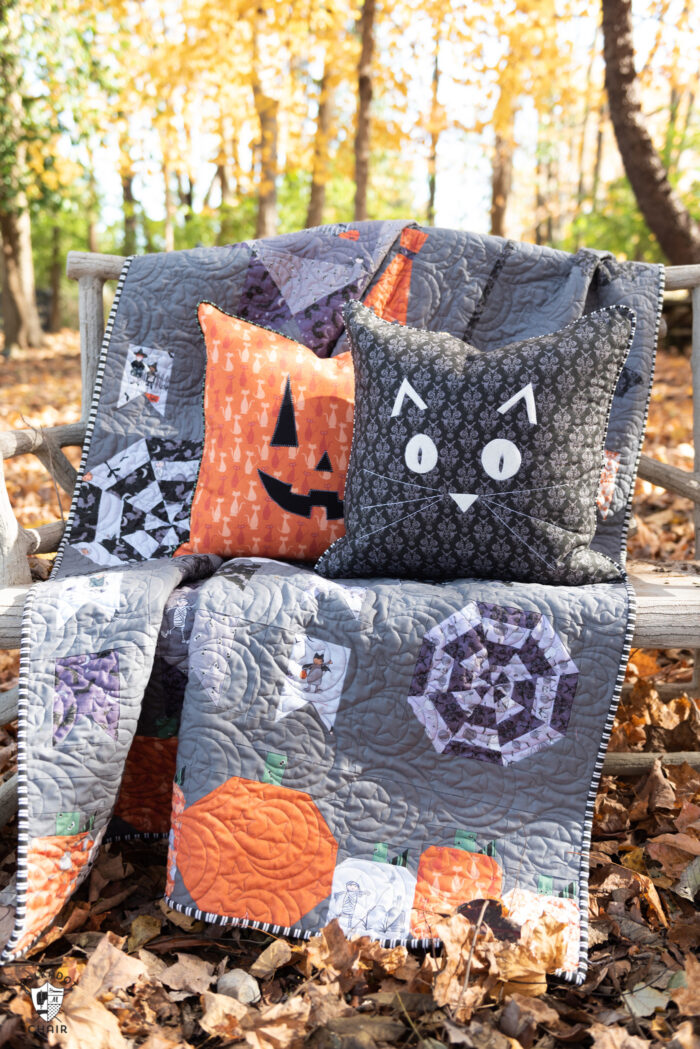 pillows and quilt on bench outdoors
