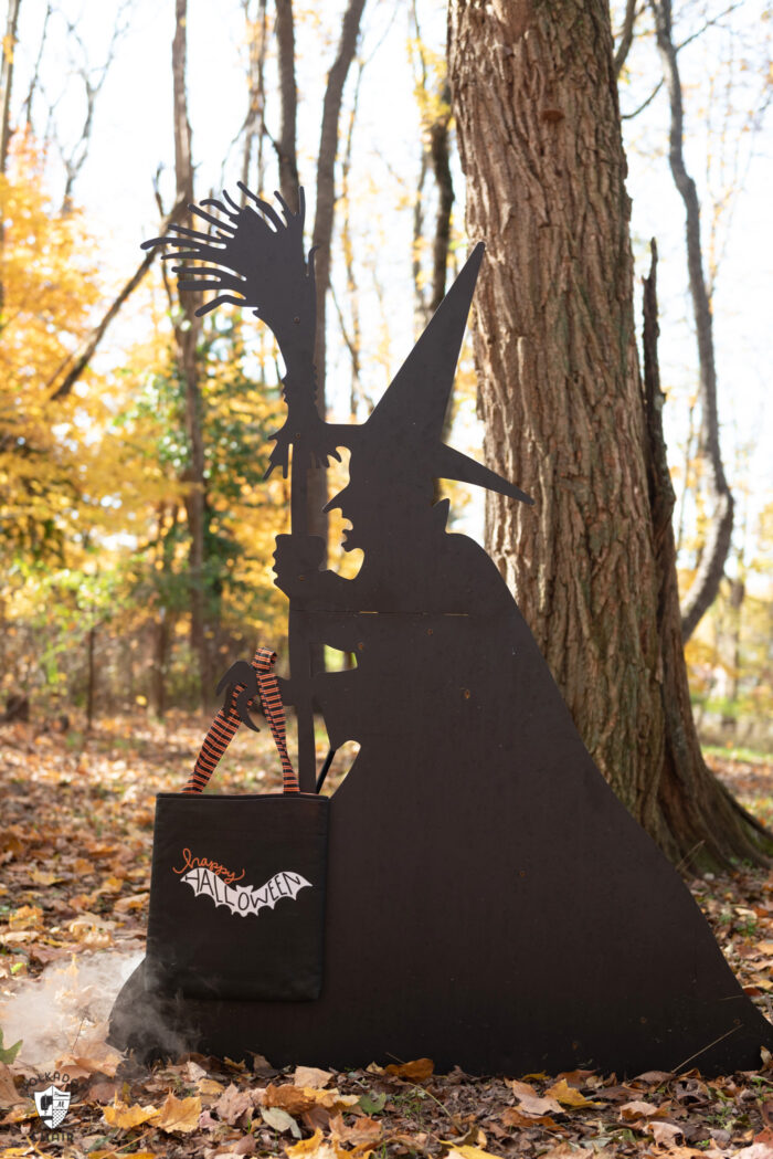 witch silhouette outdoors holding trick or treat bag