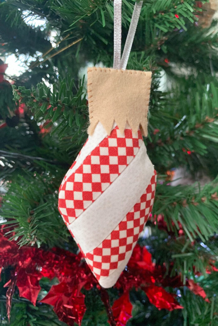 Finished scrappy Christmas ornament in red and white on Christmas Tree