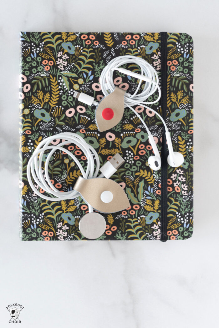 cord snaps around headphones on black floral book