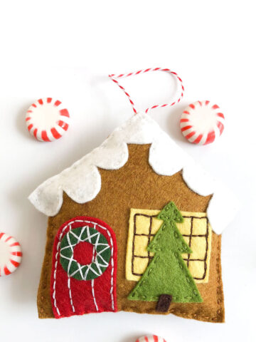 gingerbread house ornament on white table