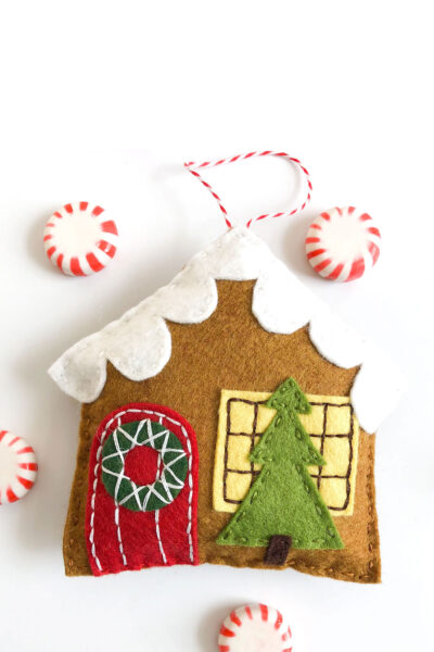 gingerbread house ornament on white table