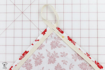 hand folding fabric on white cutting mat