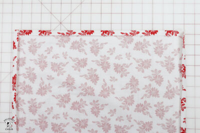 hand folding fabric on white cutting mat