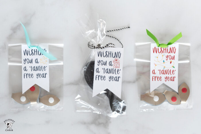 gift bags with cord snaps and tags on white marble table
