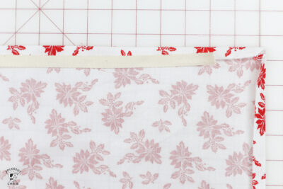 hand folding fabric on white cutting mat