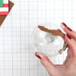 Christmas ornament with paper glued on on white cutting mat