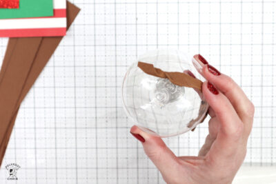 Christmas ornament with paper glued on on white cutting mat