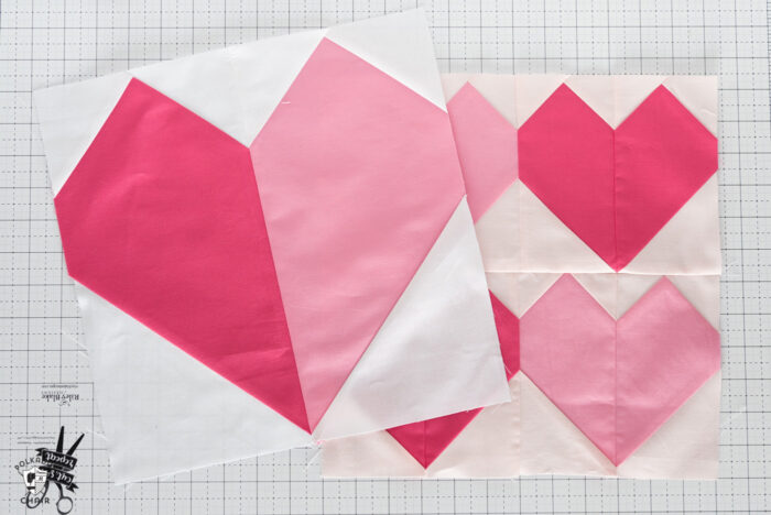 Pink and white heart quilt block on white cutting mat