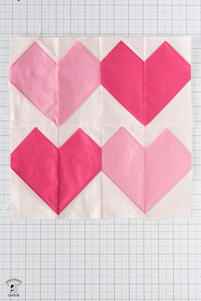 pink and dark pink quilt blocks on white cutting mat