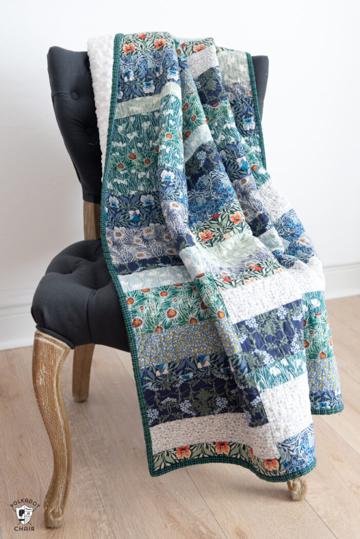 photo of a blue, green quilt on gray chair