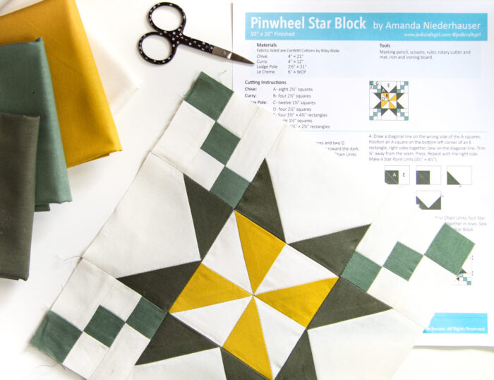 yellow and green quilt block from liberty of london fabrics on white cutting mat