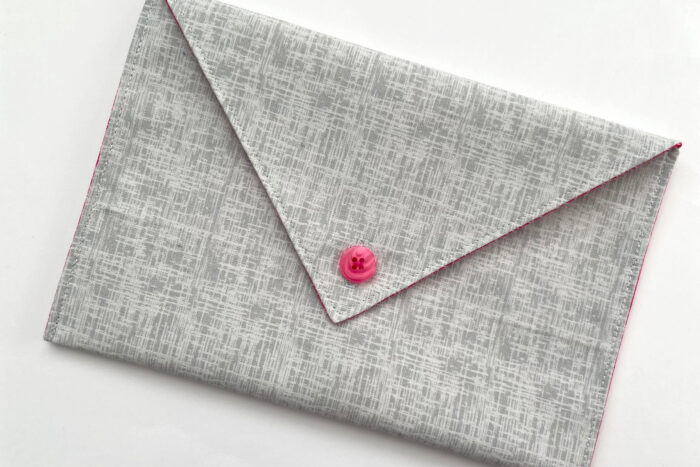 gray fabric envelope on white table