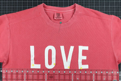 Love cut out on coral sweatshirt