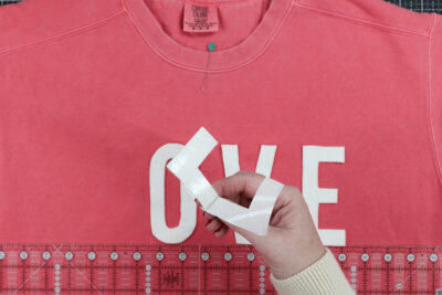 Love cut out on coral sweatshirt