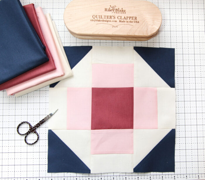 blue pink quilt blocks on white cutting mat