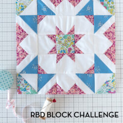 Blue, white and pink quilt block on white cutting mat