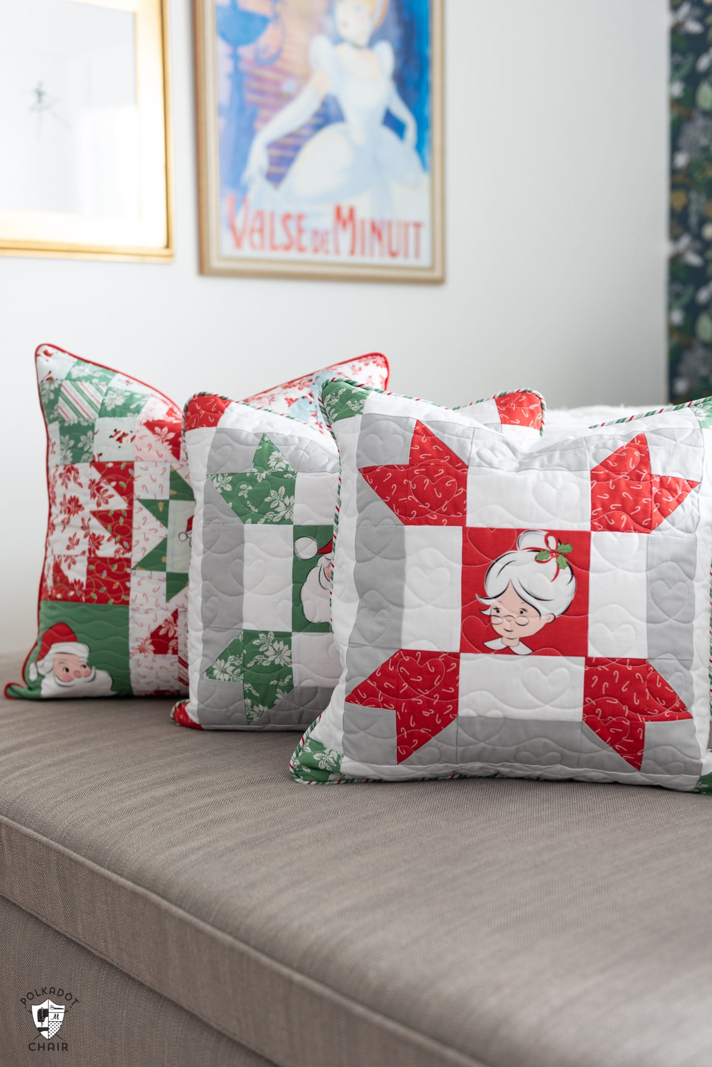 red, green and white patchwork christmas pillows on gray bench