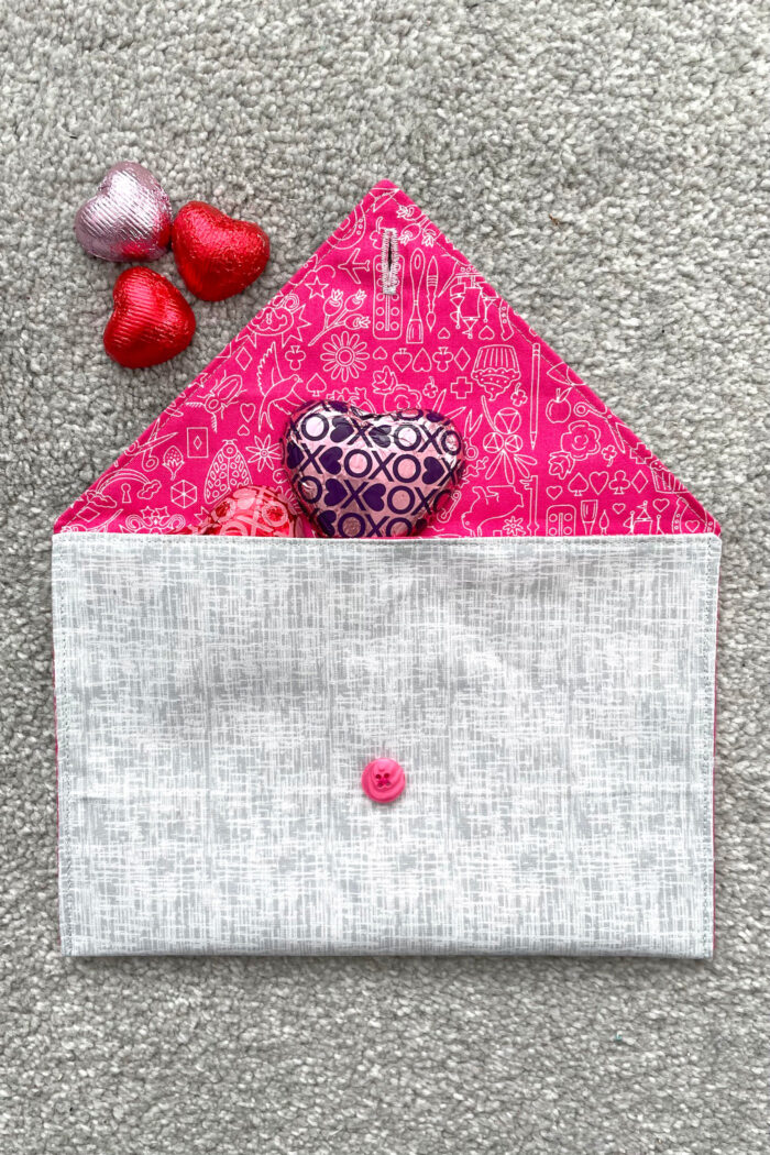 gray and pink fabric envelope on gray carpet