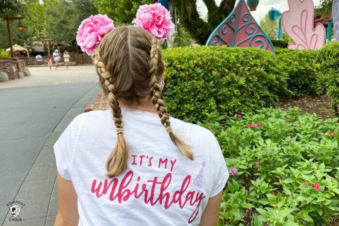 girl standing in front of ride at disneyworld