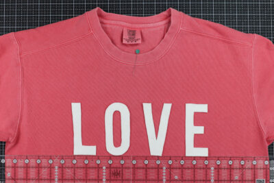 Love cut out on coral sweatshirt