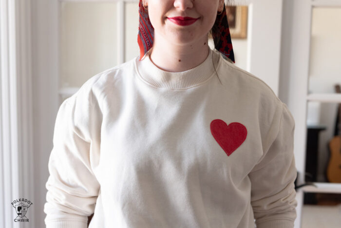 girl in ivory heart sweatshirt sitting on stairs