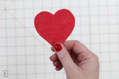 hand holding red cut out heart