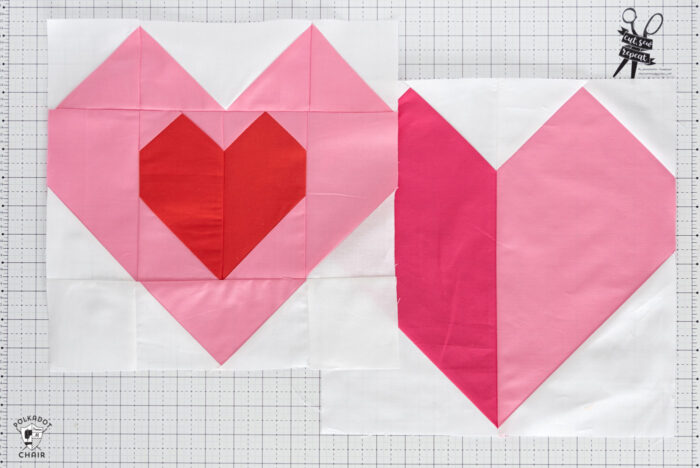 Pink and red heart quilt block on white cutting mat