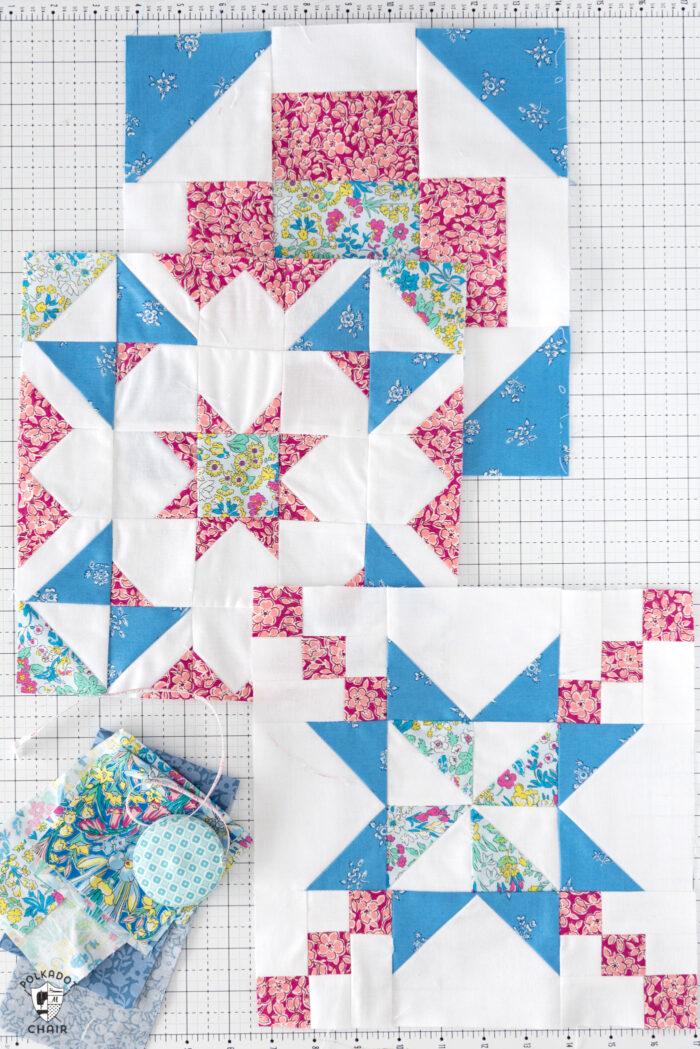 blue pink and floral quilt blocks on white cutting mat