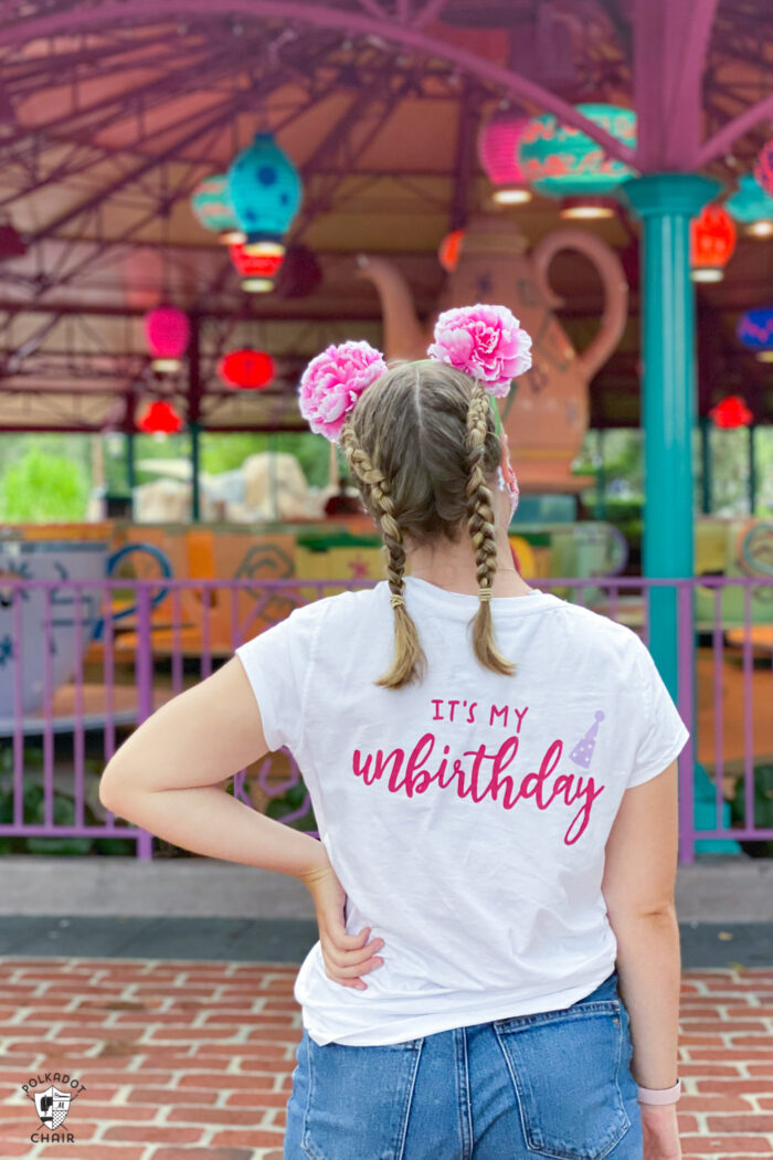 girl standing in front of ride at disneyworld