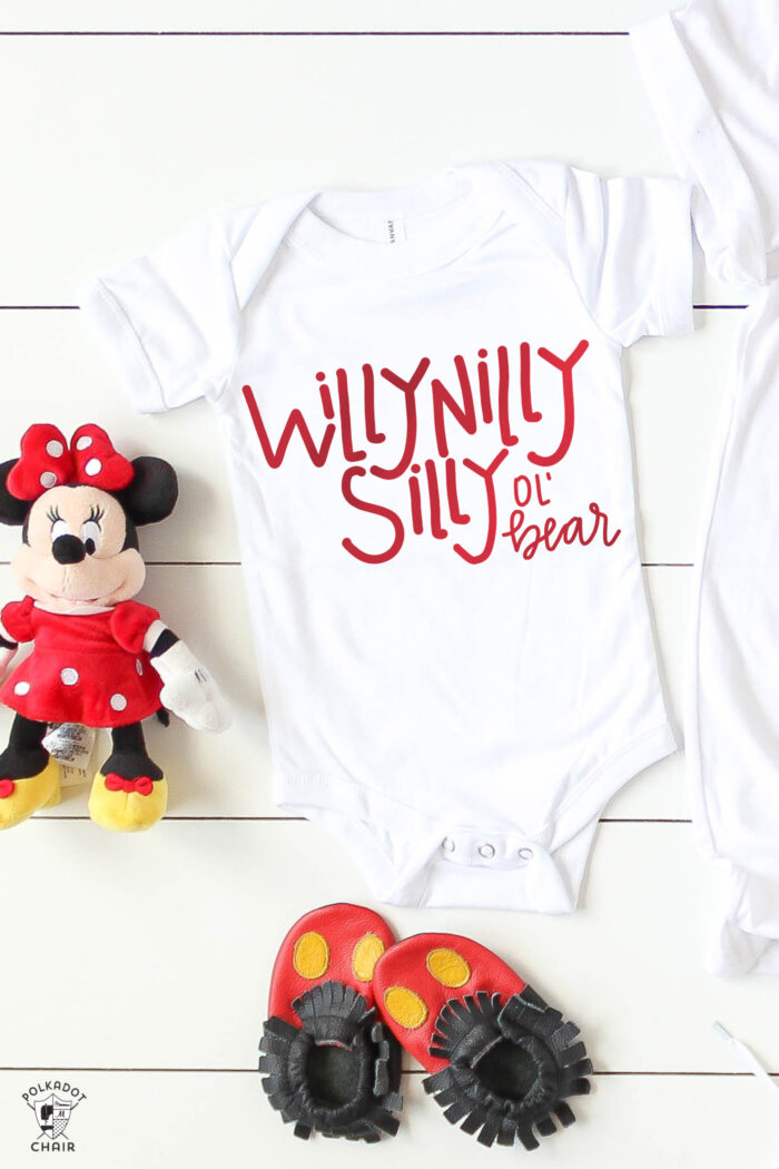 white baby onesie, minnie mouse on white table