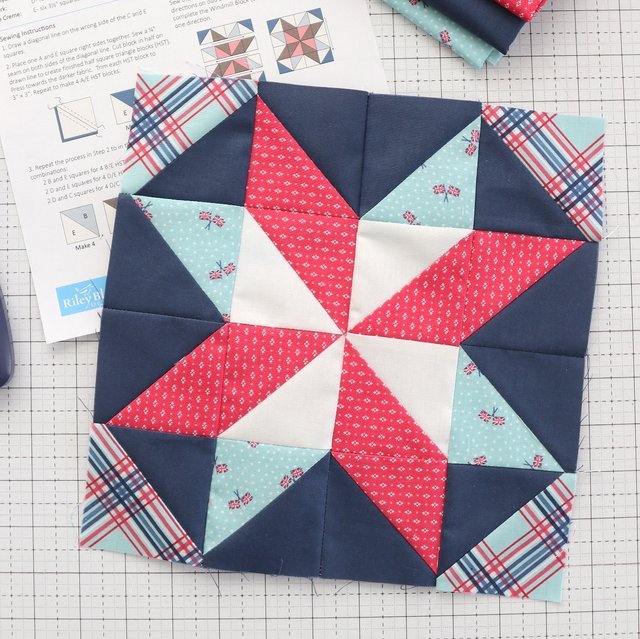 red white and blue quilt block on white cutting mat