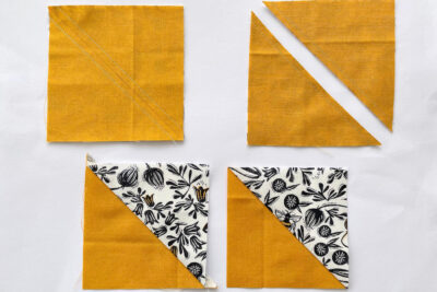 green white and yellow half square fabric triangles on white table