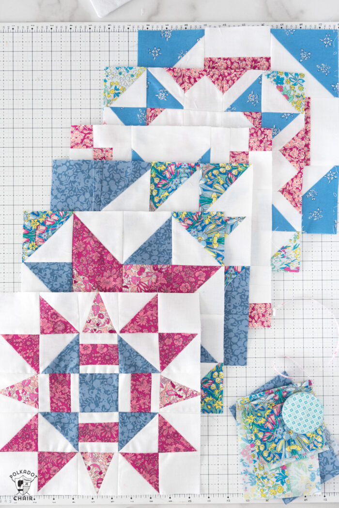 multiple red pink and white quilt block on white cutting mat